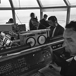 Air traffic controllers in the control tower at Heathrow Airport handling departing