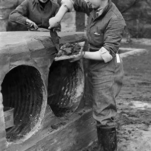 Army Women. A. T. S. Cooks seen here building a training tunnel an assault course