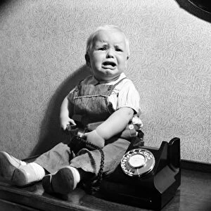 Baby and telephone. August 1952 C4052