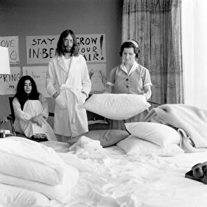 Beatle John Lennon and his wife Yoko Ono stage a public bed in