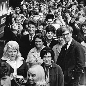 Beatles fans wait patiently to buy tickets from the box-office of the Odeon cinema