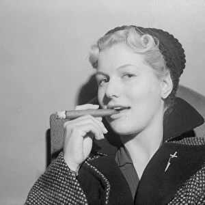 British actress Mary Germaine seen here smoking a cigar. 18th September 1952