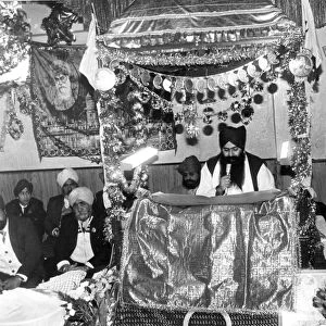 Cardiff - Religion - Priest Charananjit Singh holds a reading at the Sikh temple in