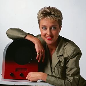 Cathy McDonald television presenter September 1989 leaning on an old radio wireless