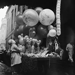 Children with balloons during Christmas shopping scenes in Regent Street, London
