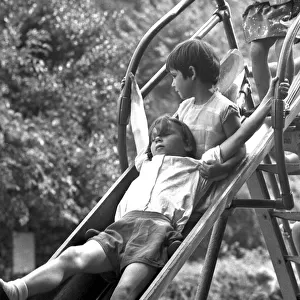 Children play on a slide at The War Memorial Park, Coventry. 28th August 1967