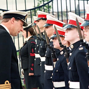 Commander J Robertson inspects the guard of honour provided by the Marines detachment