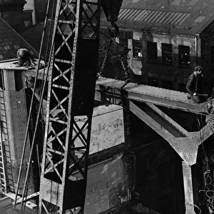 Construction of the new Tyne Bridge. A large crowd were keenly interested in the lifting