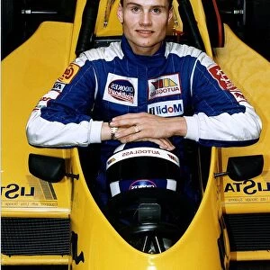 David Coulthard sitting in car indoors racing camel