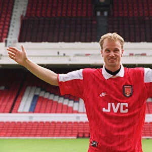 Dennis Bergkamp demonstrates the size of his fee after signing for Arsenal for £7
