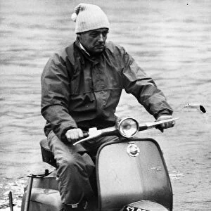 Donald Campbell rides a water scooter on Coniston Water in 1966