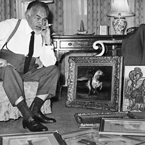 Edward G Robinson Actor 1966 takes a seat as he views a collection of art