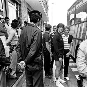 England footballers Paul Mariner and Graham Rix wait to board the bus at the team hotel