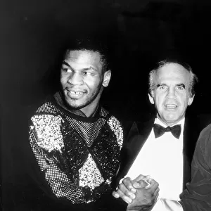 Frank Bruno Boxing and Mike Tyson shake hands watched over by promoter Micky Duff