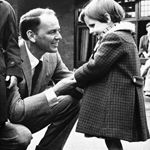 Frank Sinatra Actor and Singer talking to a little blind girl at his visit to