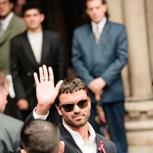 George Michael outside court after losing his battle against Sony. Wearing an AIDS ribbon