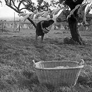 German woman hangs washing by Siegfried Line, France. Circa 1944