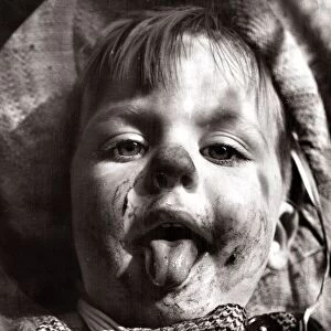 Girls face after eating chocolate, circa 1950