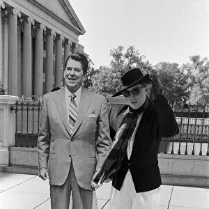 Holly Johnson posing outside the White House with a full-size cutout of Ronald Reagan