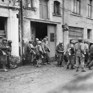 Infantrymen gather in Bastogne, Belgium to regroup after being cut away from their