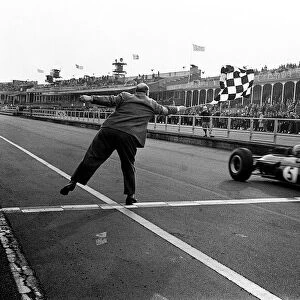 Jack Brabham gets the Chequered flag at the end of the Aintree International 200