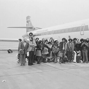The Jackson Five pop group stand beside their plane as they arrive at London airport