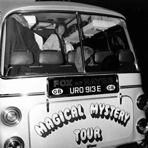 John lennon looks out of the back window of the Magical Mystery Tour Bus as The Beatles