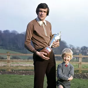 Leeds United footballer Norman Hunter with his five year old son Michael holding