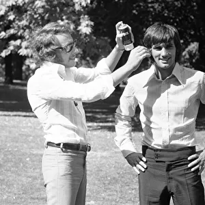 Manchester United footballer George Best has hair spray appiled by his personal