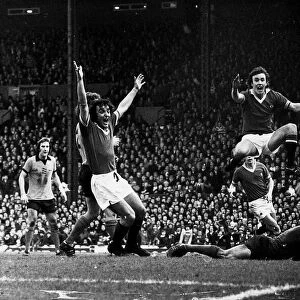 Manchester United footballers Lou Macari and Sammy McIlroy celebrates a goal by Gerry