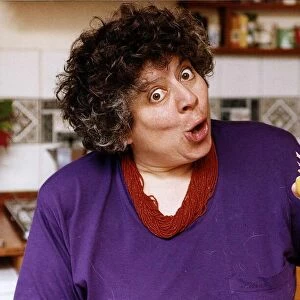 Miriam Margolyes actress eating an orange and pulling a face