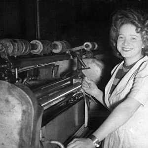 Miss Jessie Lawton, at her machine in the munitions factory in Birmingham