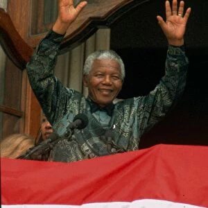 Nelson mandela waves to the crowd in Trafalgar Square during his visit to England