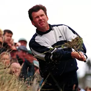 Nick Faldo hits out of the rough after a bad tee shot during the third round of the Open