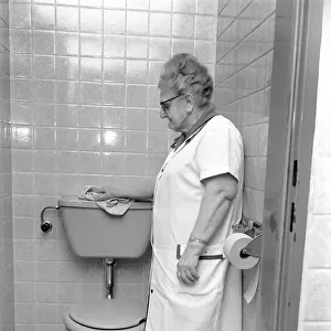 An old woman cleaning the toilet. November 1969 Z10818-001