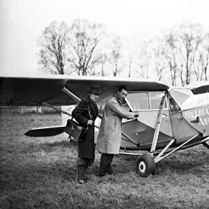 Passengers board a Hillmans Airways Puss Moth aircraft. 18th March 1932