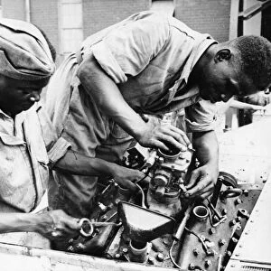 The Pioneer Corps (East African Division) making adjustments to a Bren Gun Carrier