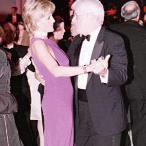 Princess Diana dances with American chat show host Phil Donahue at a charity gala dinner