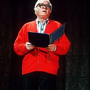 Richard Attenborough speaking wearing a red cardigan