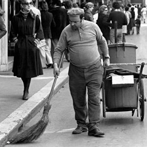 A road sweeper cleaning the streets in a poor suburb on the outskirts of Rome