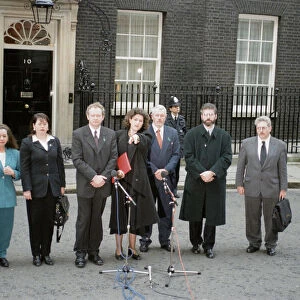 Sinn Fein leader Gerry Adams flanked by his party deputies faces the media outside Number