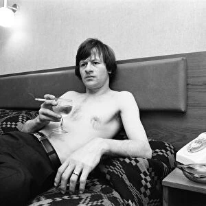 Snooker player Alex Hurricane Higgins relaxing with a drink