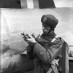 A soldier during WW2 holding a homing pigeon