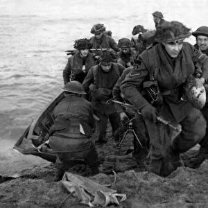 Soldiers of a Scottish infantry division of the British Army leave their assault craft