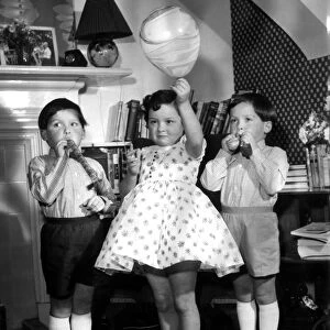 Triplet children dressed for clothing Feature. 2nd January 1959