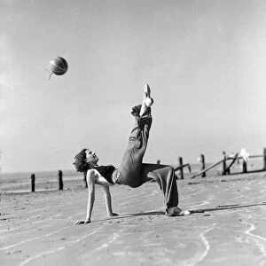Woman playing on the beach at Elmer Sands, West Sussex. August 1933 1102