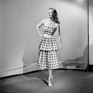 Woman wearing checked dress October 1952 C5178-001
