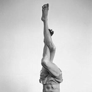 Yoga positions. Position is called Eagle in Tripod Headstand