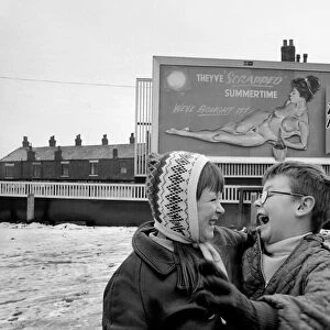 A young couple are highly amused by Nude Billboard Advert. December 1970 71-00003-004