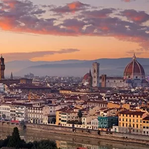 Florence, Italy skyline with landmark buildings at dusk over the Arno River